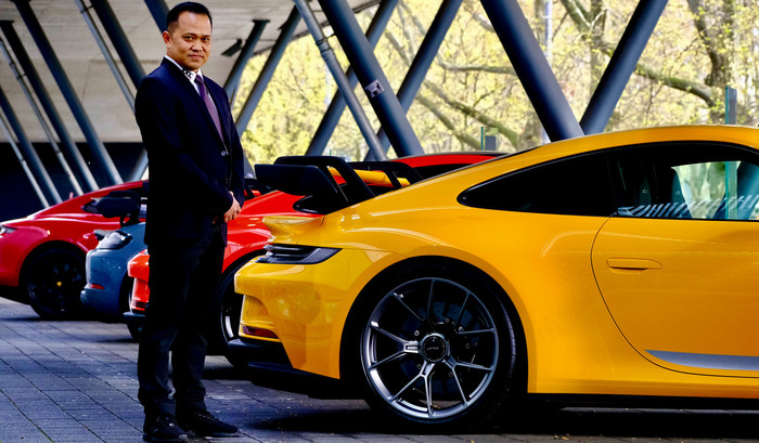 Sicherheitsmitarbeiter im Anzug vor hochwertigen Sportwagen (Porsche) bei einer Veranstaltung von Porsche
