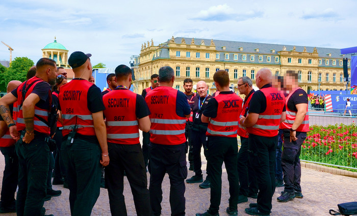 Gruppe von Sicherheitsmitarbeitern im Austausch während einer Großveranstaltung am Stuttgarter Schlossplatz